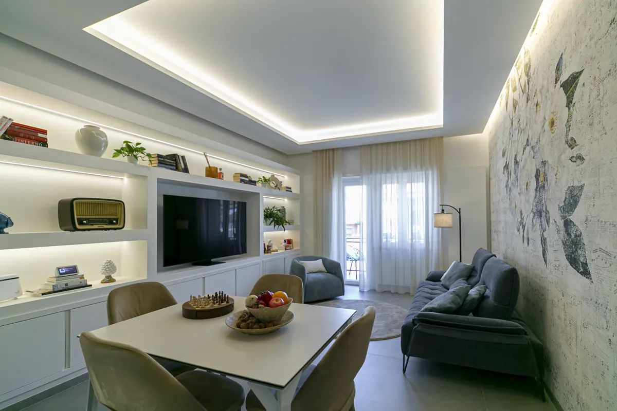 Soggiorno moderno con parquet e boiserie dopo la ristrutturazione